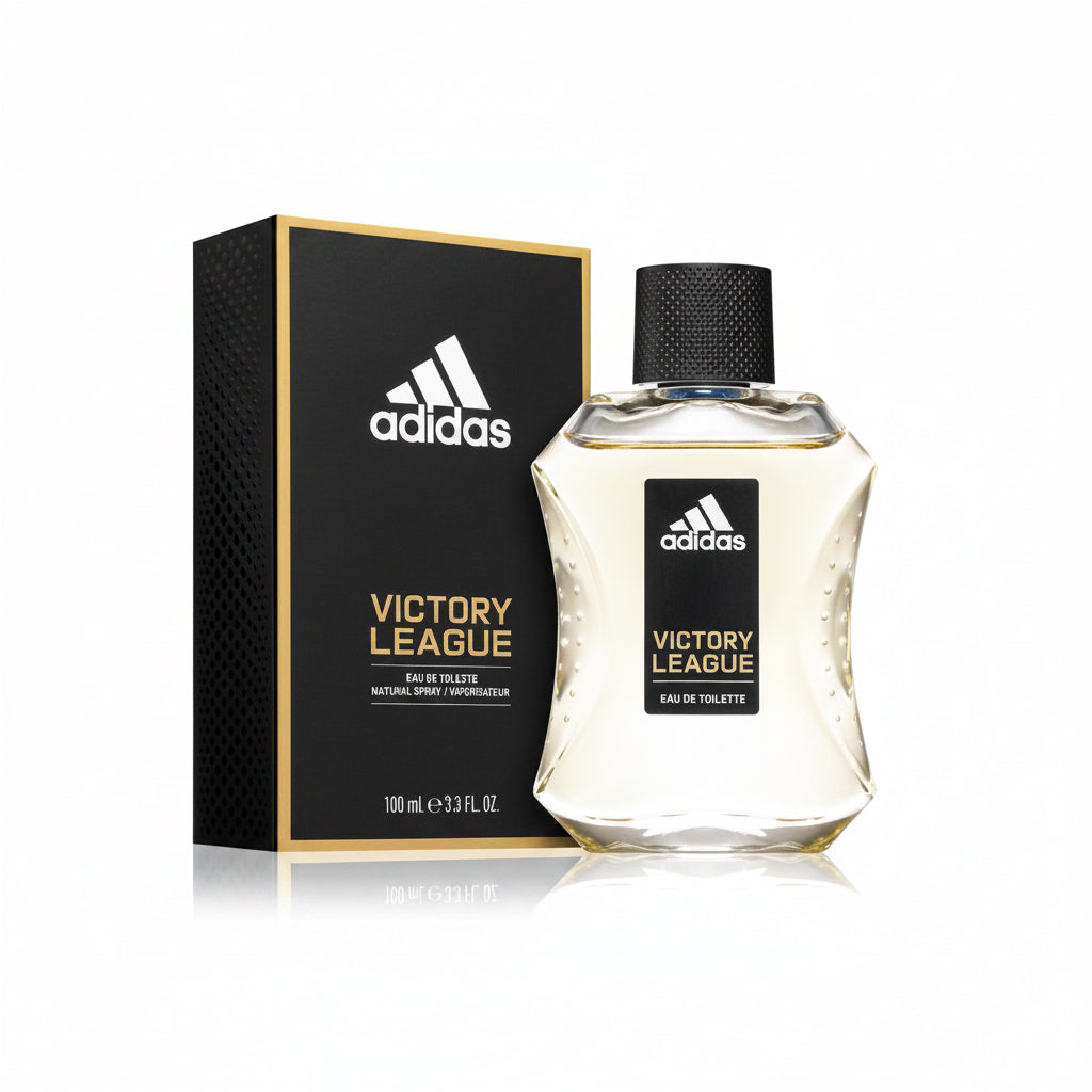 Adidas Victory League Eau de Toilette bottle with its black and gold packaging box, displayed on a reflective white surface against a black background.