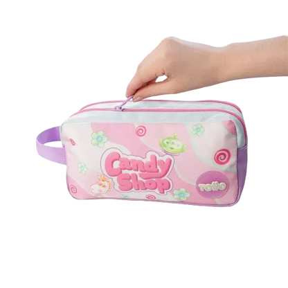 A pink and white zippered pencil case with a purple handle, decorated with 'Candy Shop' and 'relie' graphics, held by two hands against a white background.