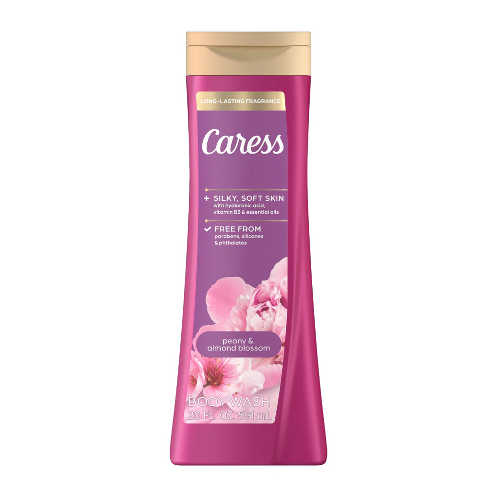 A bottle of Caress Peony & Almond Blossom body wash, featuring a vibrant magenta pink bottle with a gold cap and floral graphics, set against a plain white background.