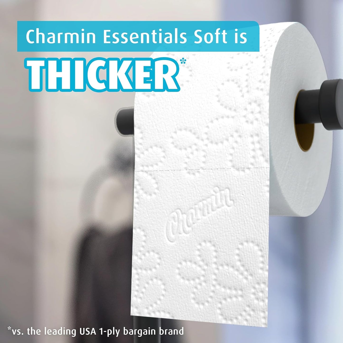 Roll of Charmin toilet paper on a holder with text highlighting its thickness comparison.